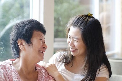 Daughter having conversation with senior mother