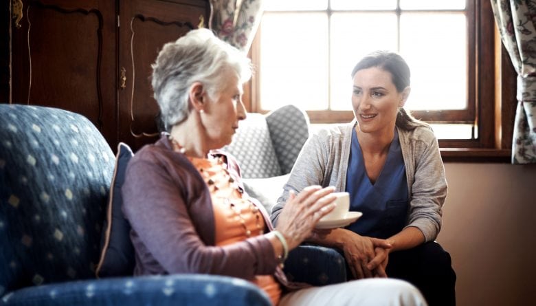 Senior woman chatting to her caretaker