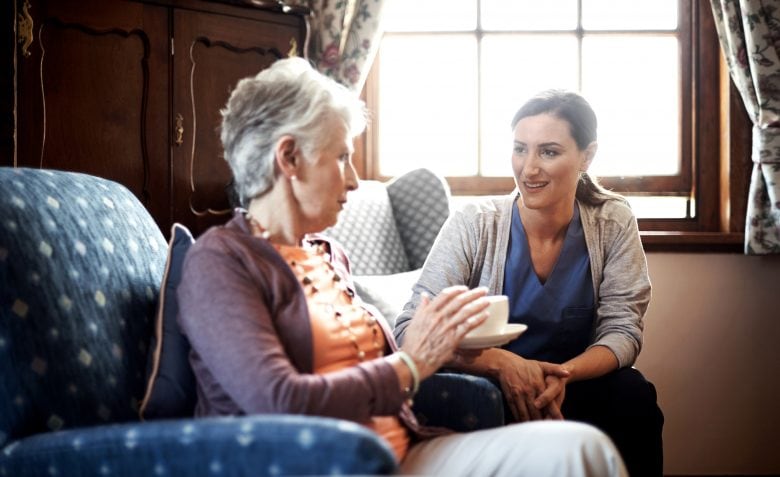 Senior woman chatting to her caretaker